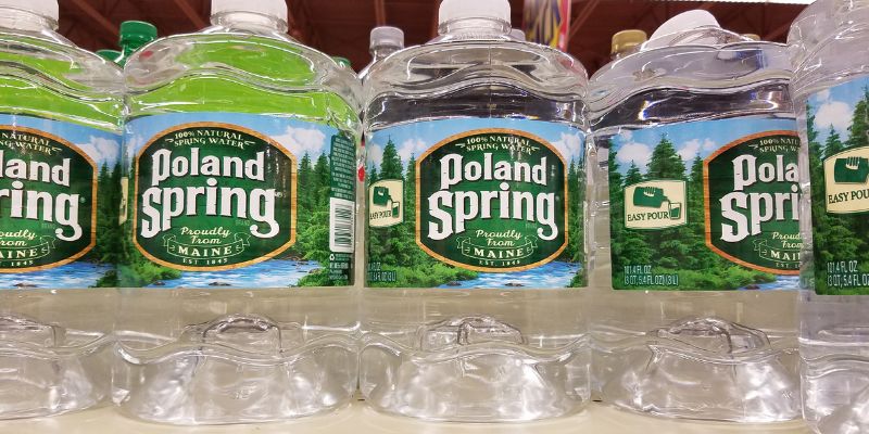 Gallon spring water bottles on a store shelf